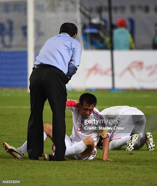 Head coach Yun Jongsu of North Korea consoles Jang Songhyok after the 0-1 defeat in the Football Men's Gold Medal match between South Korea and North...