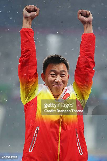 Zhao Qinggang of China celebrates atop the podium after claiming the Gold medal and setting a new Asian and Games record in the Men's Javelin Throw...