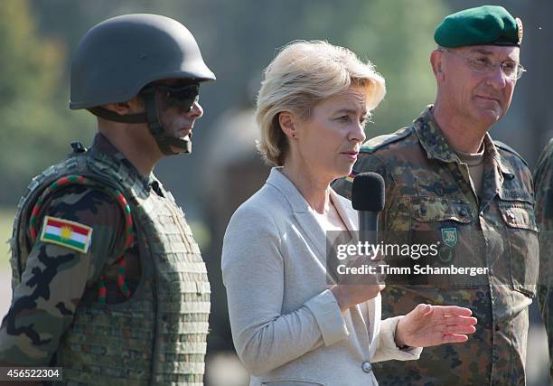 German Defence Minister Ursula von der Leyen speaks next to German General Gert-Johannes Hagemann and a peshmerga fighter on October 02, 2014 in...