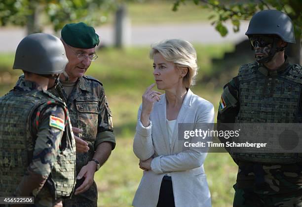 German Defence Minister Ursula von der Leyen speaks to a peshmerga fighter next to German General Gert-Johannes Hagemann on October 02, 2014 in...