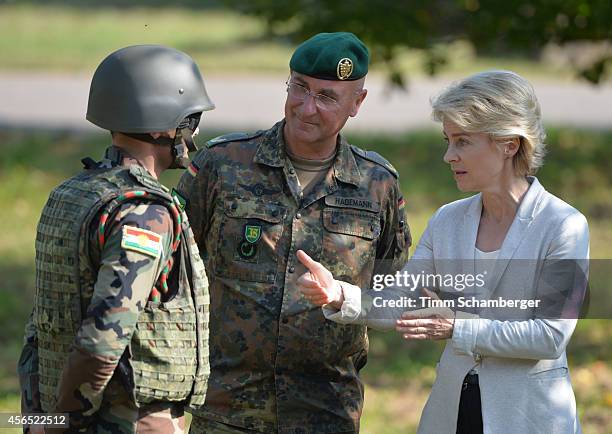 German Defence Minister Ursula von der Leyen speaks to a peshmerga fighter next to German General Gert-Johannes Hagemann on October 02, 2014 in...
