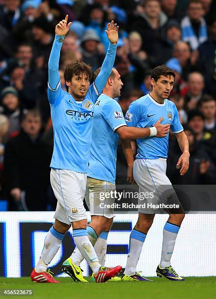 David Silva of Manchester City celebrates scoring their fourth goal during the Barclays Premier League match between Manchester City and Arsenal at...