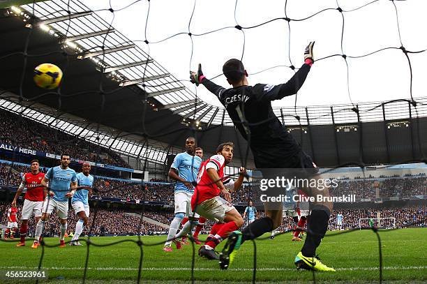 Wojciech Szczesny of Arsenal can't stop Sergio Aguero of Manchester City scoring their first goal during the Barclays Premier League match between...