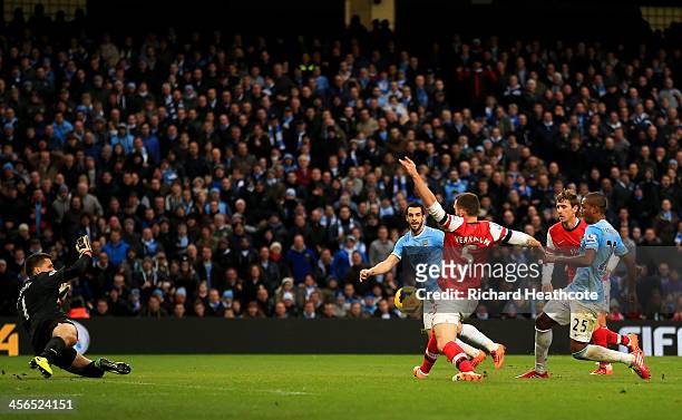 Fernandinho of Manchester City scores their fifth goal past Wojciech Szczesny of Arsenal during the Barclays Premier League match between Manchester...