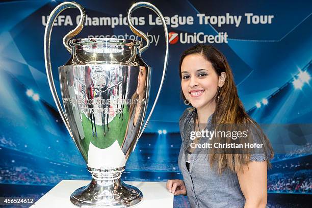 Visitor sieze the opportunity to have their picture taken while standing next to the UEFA Champions League Trophy during the Unicredit UEFA Champions...