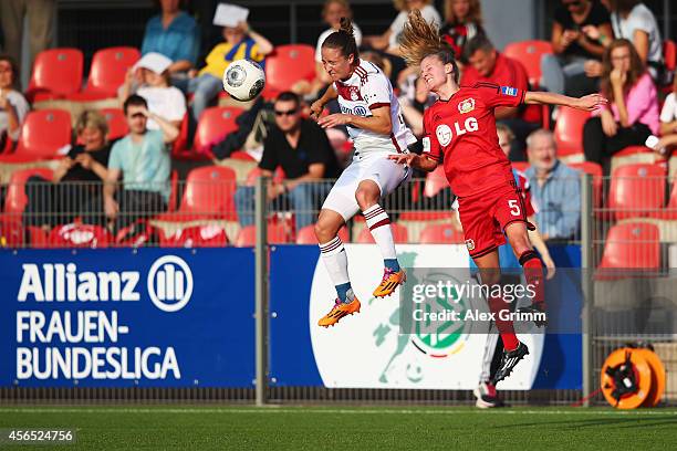 Marisa Ewers of Leverkusen is challenged by Gina Lewandowski of Muenchen during the Allianz Frauen-Bundesliga match between Bayer 04 Leverkusen and...