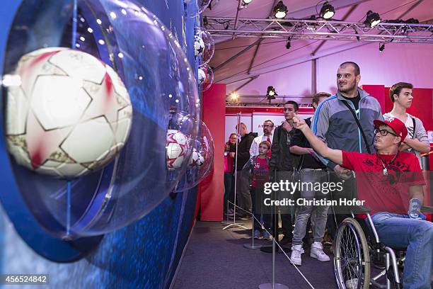 Visitors are seen gathering in the showroom during the Unicredit UEFA Champions League Trophy Tour on October 2, 2014 in Vienna, Austria.