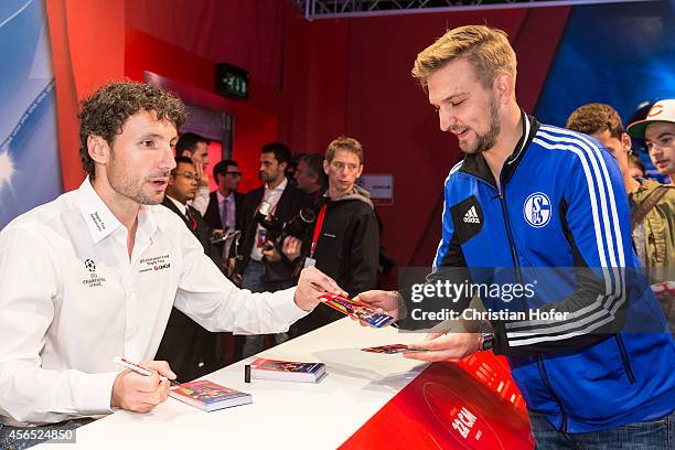Ambassador Mark van Bommel autographs cards for the fans during the Unicredit UEFA Champions League Trophy Tour on October 2, 2014 in Vienna, Austria.