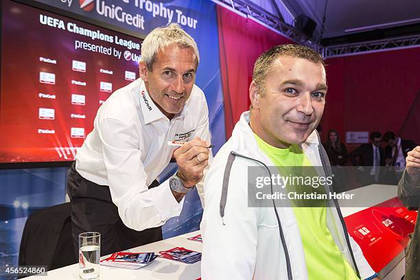 Ambassador Michael Konsel autographs cards and shirts for the fans during the Unicredit UEFA Champions League Trophy Tour on October 2, 2014 in...