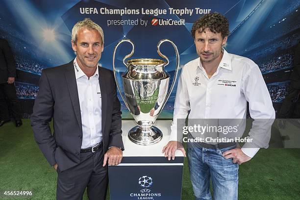 Ambassador Michael Konsel and UEFA Ambassador Mark van Bommel pose next to the UEFA Champions League Trophy during the Unicredit UEFA Champions...