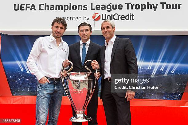 Ambassador Mark van Bommel, Bank Austria Board Member Robert Zadrazil and UEFA Ambassador Michael Konsel hold the UEFA Champions League Trophy during...