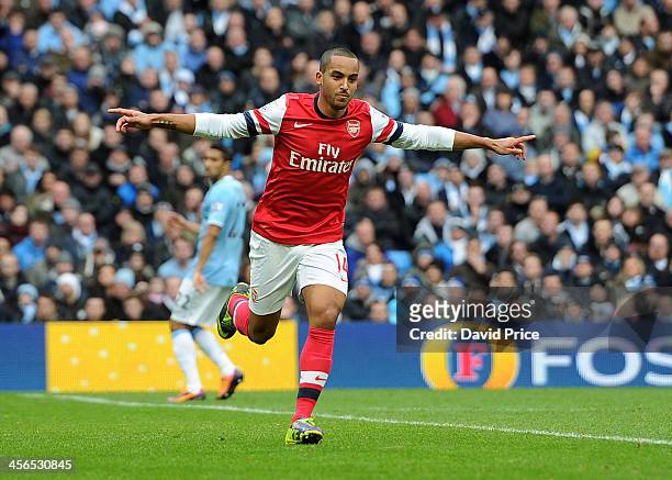 Theo Walcott of Arsenal celebrates after scoring during the Barclays Premier League match between Manchester City and Arsenal at Etihad Stadium on...