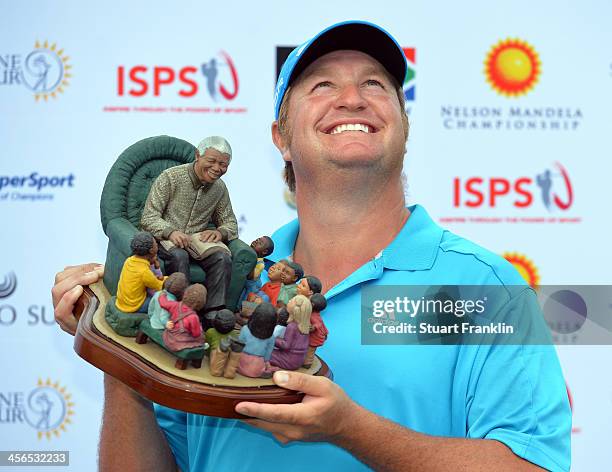 Dawie Van Der Walt of South Africa looks to the sky as he holds the trophy after winning the Nelson Mandela Championship at Mount Edgecombe Country...