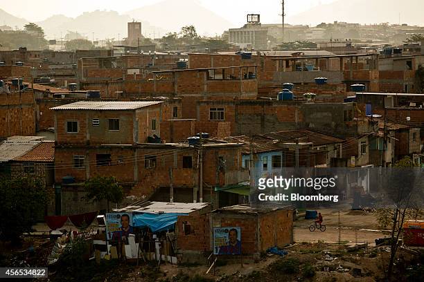 Campaign election posters are displayed on the side of a building in a shantytown, or favela, in Rio de Janeiro, Brazil, on Wednesday, Oct. 1, 2014....