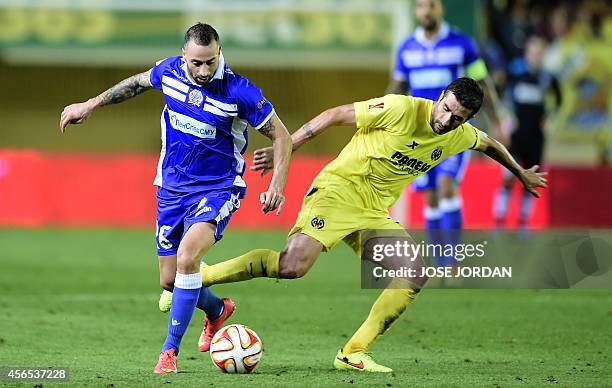 Apollon Limassol's midfielder from Greece Photis Papoulis vies with Villarreal's midfielder Cani during the Europa League football match Villarreal...