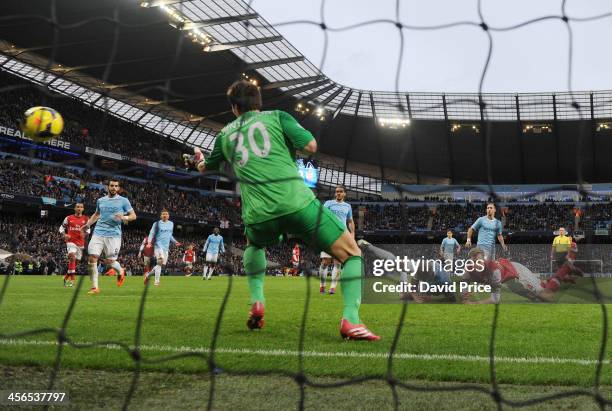 Per Mertesacker of Arsenal scores his team's third goal past goalkeeper Costel Pantilimon of Manchester City during the Barclays Premier League match...