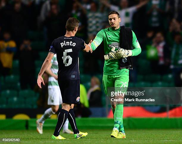 Celtic goalkeeper Craig Gordon shakes hands with Ivo Pinto of Dinamo Zagreb at the end of the UEFA Europa League group D match between Celtic and...