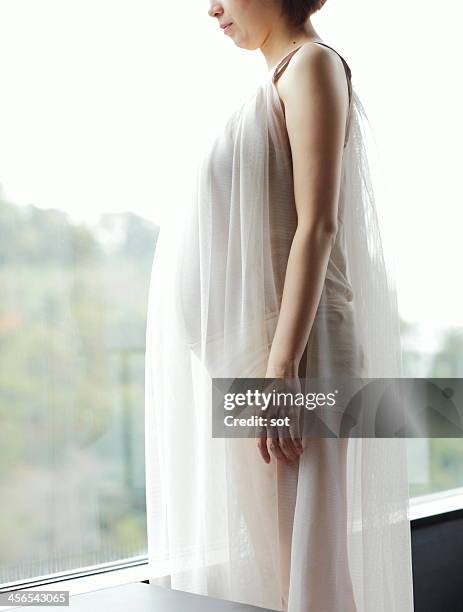 pregnant woman in front of window - see thru nightgown stock pictures, royalty-free photos & images