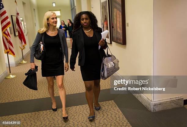 Andrea Powell, left, the director of FAIR Girls, and Kiana McWeay, right, walk to a City Council meeting July 10, 2014 in Washington, DC. FAIR Girls...