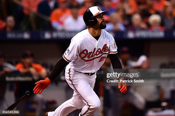 Nick Markakis of the Baltimore Orioles hits a RBI single to right center field in the second inning to score Ryan Flaherty against Max Scherzer of...