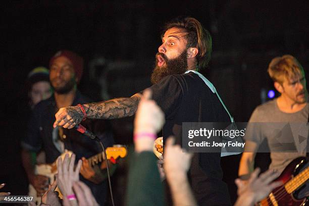 Vocalist Jason Aalon Butler of the band Letlive performs injured with his arm in a cast at The Emerson Theater on December 13, 2013 in Indianapolis,...