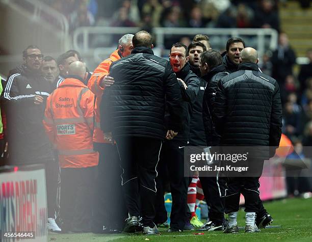 Goalkeeping Coach of Newcastle United Andy Woodwin is reprimanded by Fourth official Kevin Friend after a tussle with Manager of Southampton Mauricio...