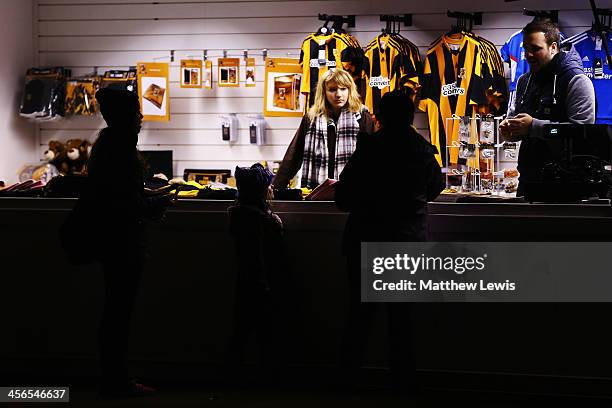 Fans queue at a merchandise stand before the Barclays Premier League match between Hull City and Stoke City at KC Stadium on December 14, 2013 in...