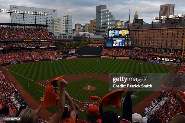 Fans cheer as Chris Tillman of the Baltimore Orioles throws a pitch in the first inning against the Detroit Tigers during Game One of the American...