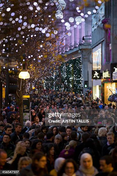 People crowd Oxford Street, one the main shopping streets in central London on December 14 with only two weekends to go until Christmas. AFP...