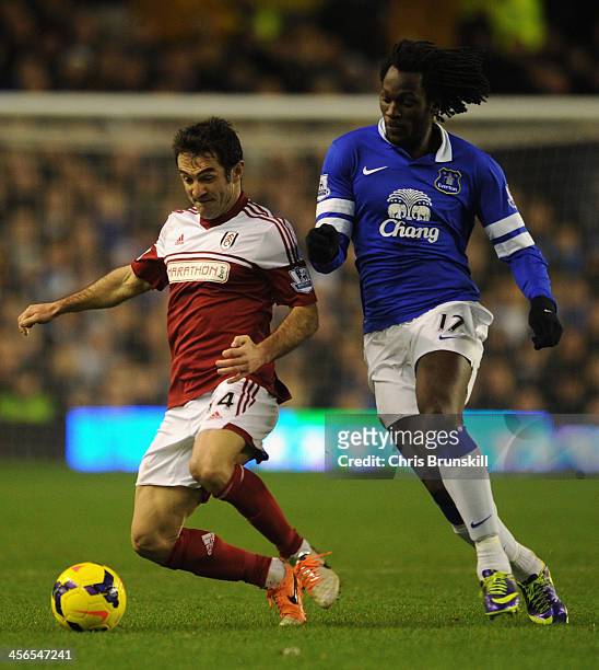 Romelu Lukaku of Everton competes with Giorgos Karagounis of Fulham during the Barclays Premier League match between Everton and Fulham at Goodison...