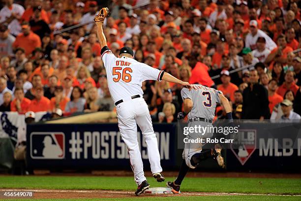 Ian Kinsler of the Detroit Tigers beats the throw to first base on an infield single as pitcher Darren O'Day of the Baltimore Orioles covers the base...