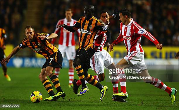Yannick Sagbo of Hull City holds off the challenge of Steven NZonzi of Stoke City during the Barclays Premier League match between Hull City and...