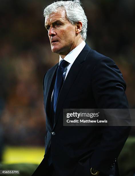 Stoke City manager Mark Hughes looks on during the Barclays Premier League match between Hull City and Stoke City at KC Stadium on December 14, 2013...