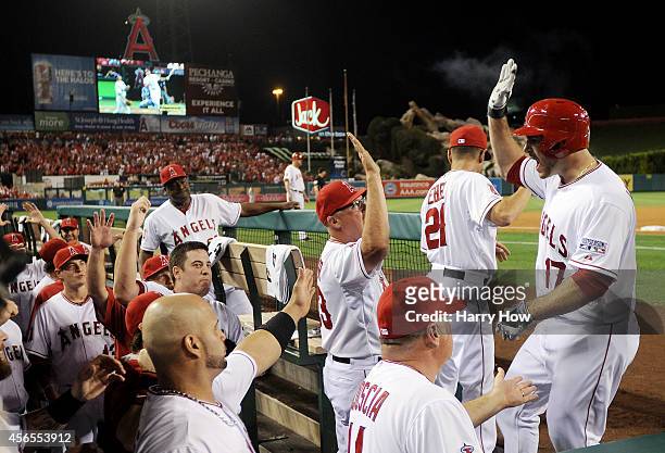 Chris Iannetta of the Los Angeles Angels returns to the dugout after hitting a home run in the third inning against the Kansas City Royals during...