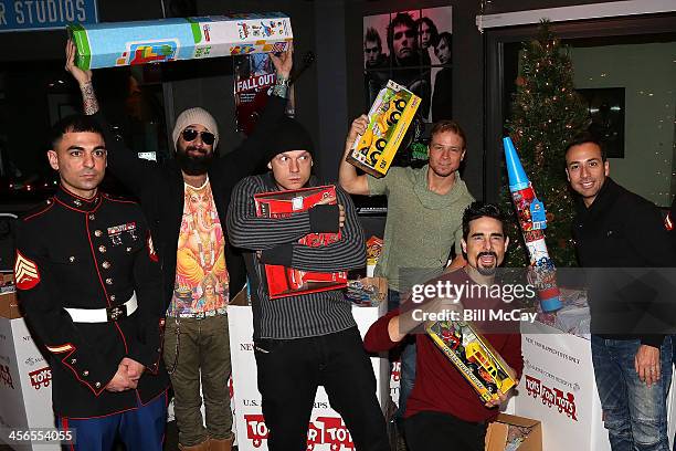 Marine Corps Sargeant Cranney, A.J. Maclean, Nick Carter, Brian Littrell, Kevin Richardson and Howie Dorough of The Backstreet Boys attend the Mix...