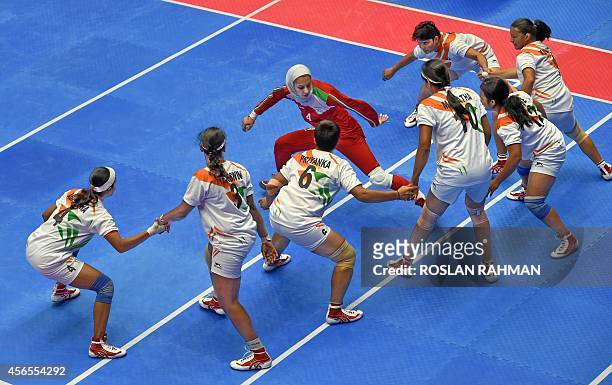 India's team try to touch down Iran's Malihe Miri during their women's Kabaddi finals of the 17th Asian Games in Incheon on October 3, 2014 AFP PHOTO...