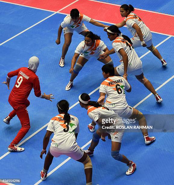 Iran's players try to touch out India's player during their women's Kabaddi finals of the 17th Asian Games in Incheon on October 3, 2014 AFP PHOTO /...