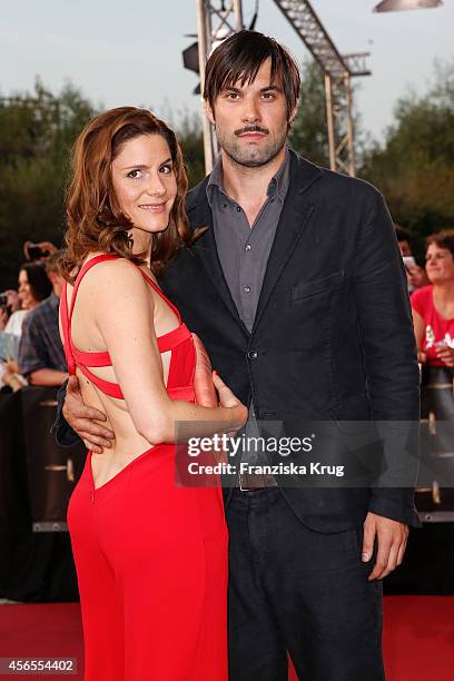 Max Simonischek and guest attend the red carpet of the Deutscher Fernsehpreis 2014 on October 02, 2014 in Cologne, Germany.