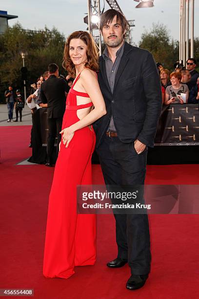 Max Simonischek and guest attend the red carpet of the Deutscher Fernsehpreis 2014 on October 02, 2014 in Cologne, Germany.