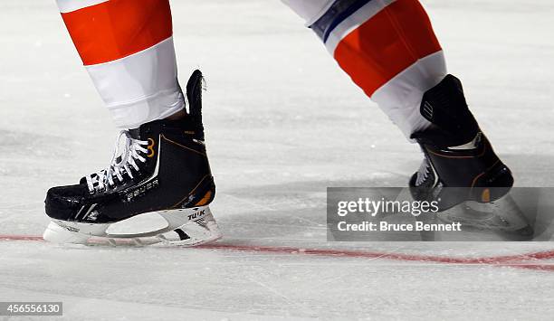 Anders Lee of the New York Islanders leaves the ice after losing his left skate blade during the game against the New Jersey Devils at the Prudential...