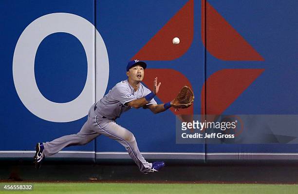 Norichika Aoki of the Kansas City Royals makes a catch in the seventh inning against the Los Angeles Angels during Game One of the American League...
