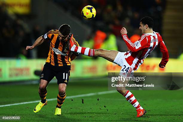 Oussama Assaidi of Stoke City tackles Robbie Brady of Hull City during the Barclays Premier League match between Hull City and Stoke City at KC...