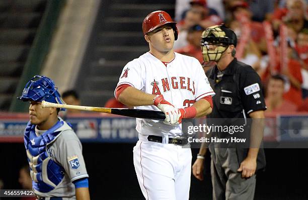 Mike Trout of the Los Angeles Angels reacts after a called strike in the eighth inning against the Kansas City Royals during Game One of the American...