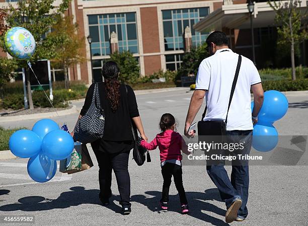 Mo Khaja, right, whose wife recently gave birth to a baby boy, faces the same challenges as the Mastrino family as he arrives at Elmhurst Memorial...