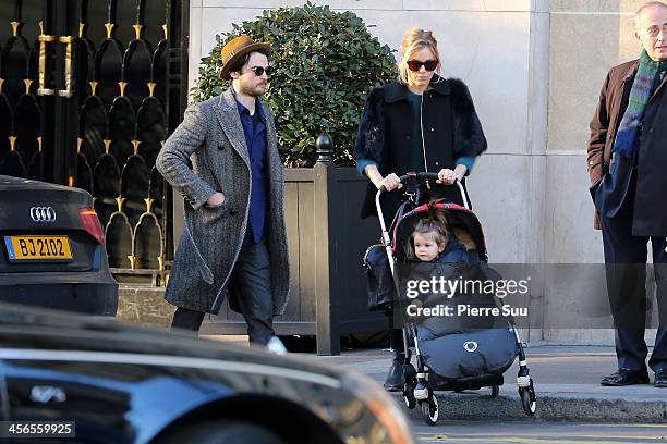 Sienna Miller, Tom Sturridge and Marlowe Sturridge leave their hotel on December 14, 2013 in Paris, France.
