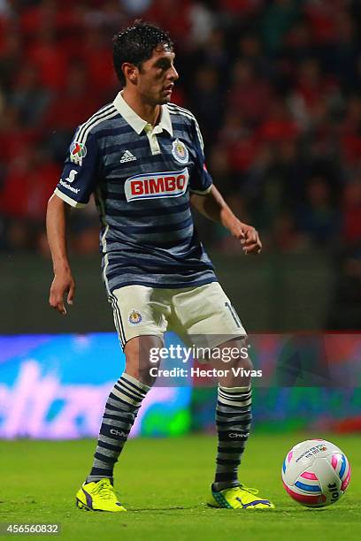 Angel Reyna of Chivas drives the ball during a match between Toluca and Chivas as part of 11th round Apertura 2014 Liga MX at Nemesio Diez Stadium on...