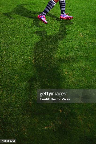 Detail of shadow and soccer shoes during a match between Toluca and Chivas as part of 11th round Apertura 2014 Liga MX at Nemesio Diez Stadium on...