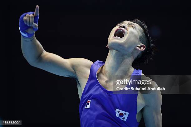 Shin Jonghun of South Korea reacts after defeating Birzhan Zhakypov of Kazakhstan during the men's light fly weight bout final on day fourteen of the...