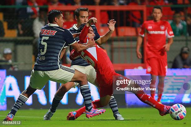 Antonio Rios of Toluca struggles for the ball with Patricio Araujo of Chivas during a match between Toluca and Chivas as part of 11th round Apertura...