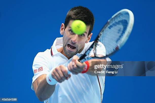 Novak Djokovic of Serbia returns a shot against Grigor Dimitrov of Bulgaria during day seven of the China Open at the National Tennis Center on...
